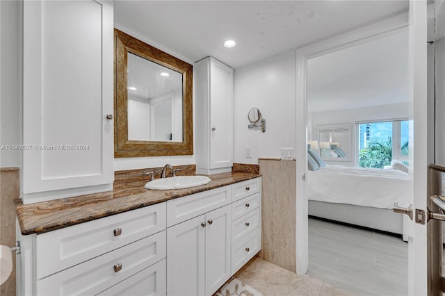 bathroom with tile patterned floors and vanity