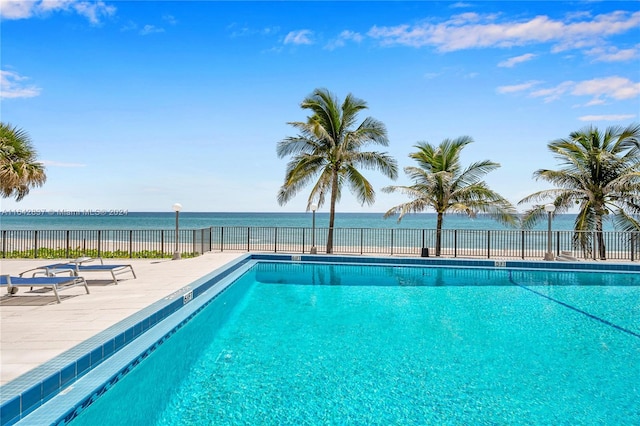 view of swimming pool with a water view