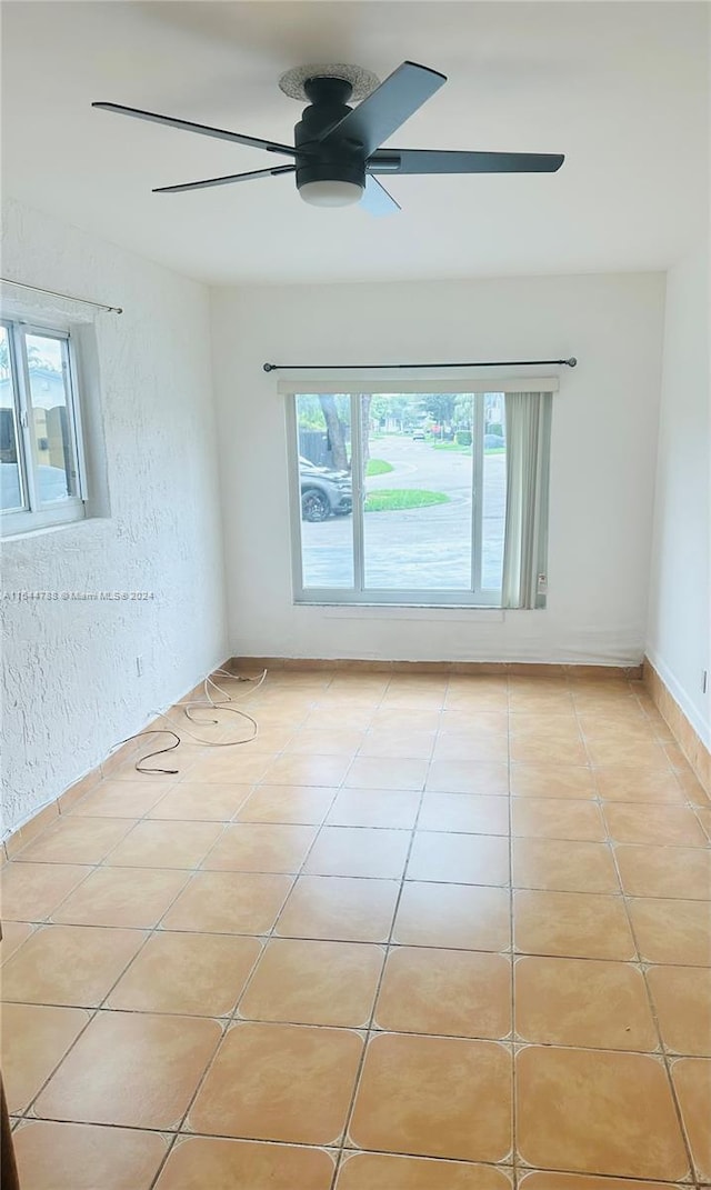 unfurnished room featuring ceiling fan and light tile patterned flooring