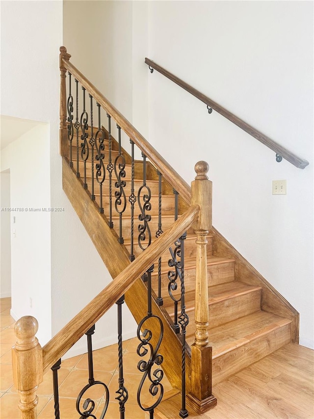 staircase featuring hardwood / wood-style floors