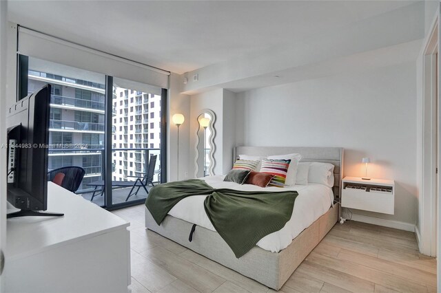 bedroom featuring access to outside and light hardwood / wood-style flooring