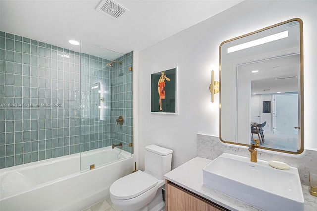 full bathroom featuring tile patterned flooring, vanity, toilet, and tiled shower / bath