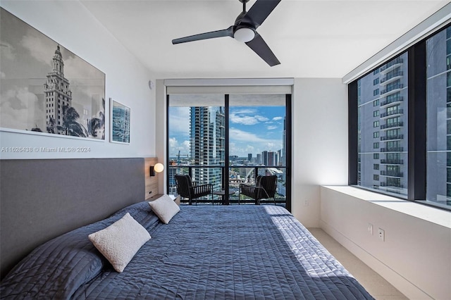 bedroom with access to outside, a wall of windows, and ceiling fan