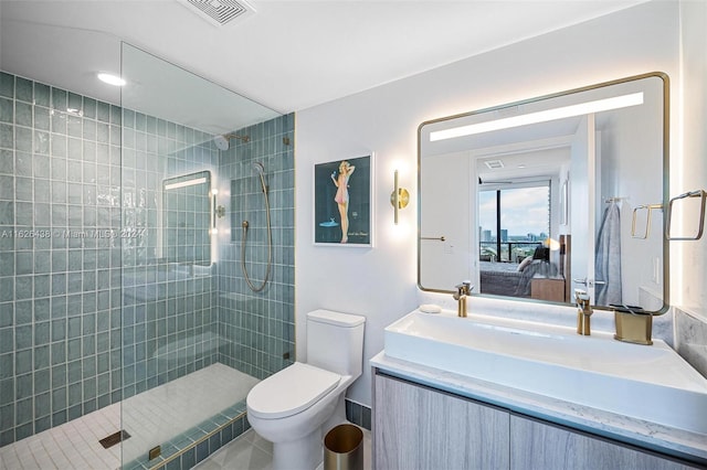 bathroom with tile patterned floors, vanity, toilet, and an enclosed shower