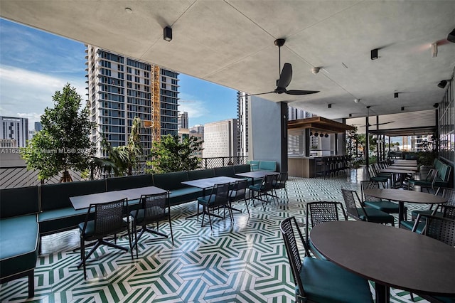 view of patio / terrace with exterior bar, an outdoor hangout area, and ceiling fan