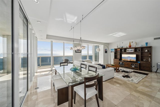 dining space with a wall of windows, visible vents, and recessed lighting