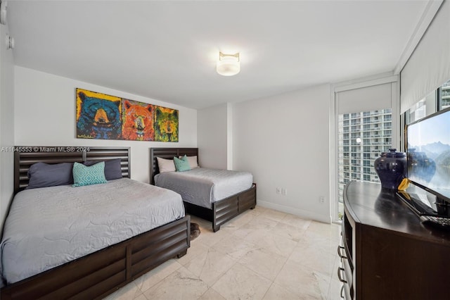 bedroom with marble finish floor and baseboards