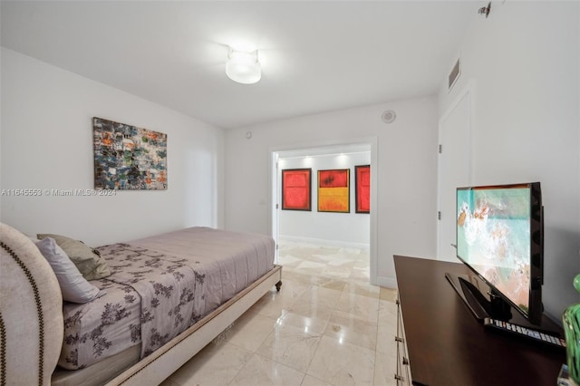 bedroom featuring marble finish floor, baseboards, and visible vents