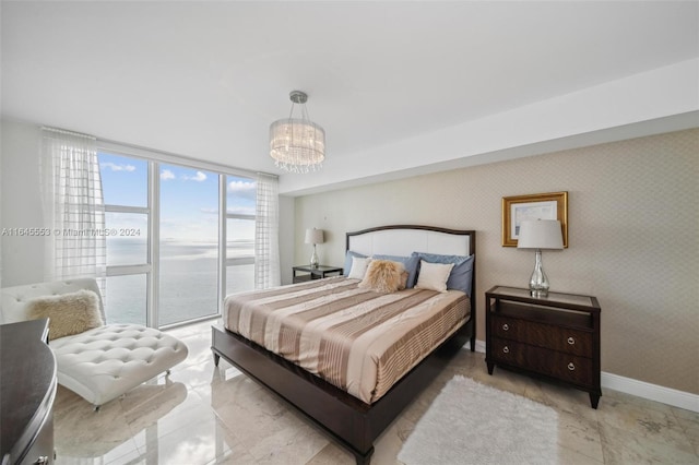 bedroom featuring floor to ceiling windows, a water view, baseboards, and wallpapered walls