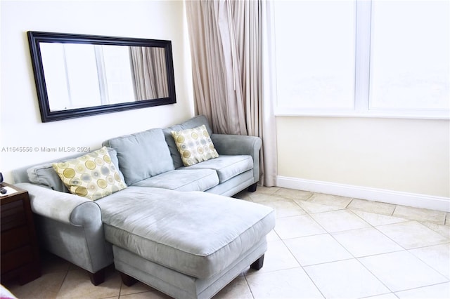 living room featuring baseboards and light tile patterned floors