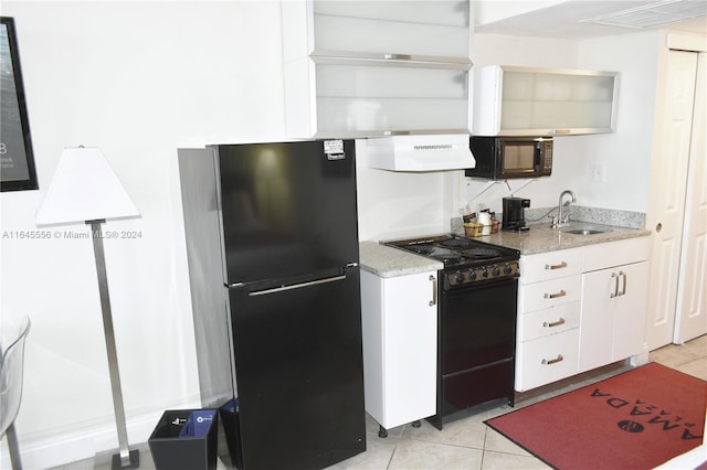 kitchen featuring white cabinets, ventilation hood, black appliances, a sink, and light tile patterned flooring