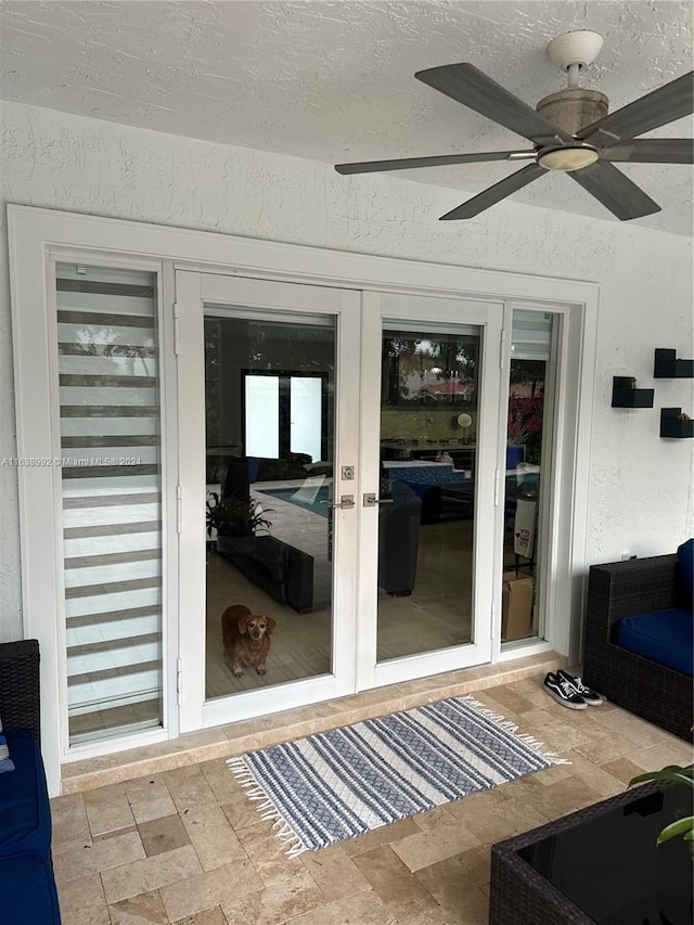 doorway to outside with a textured ceiling, ceiling fan, and french doors