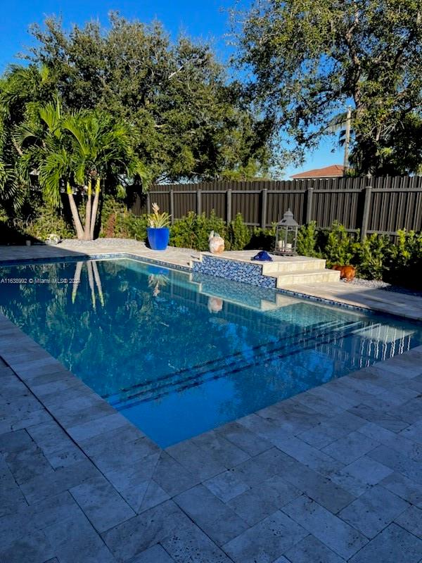 view of swimming pool with a patio