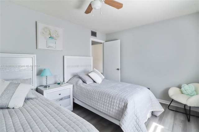 bedroom featuring dark hardwood / wood-style flooring and ceiling fan