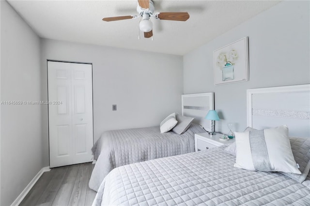 bedroom with a closet, ceiling fan, and light hardwood / wood-style floors