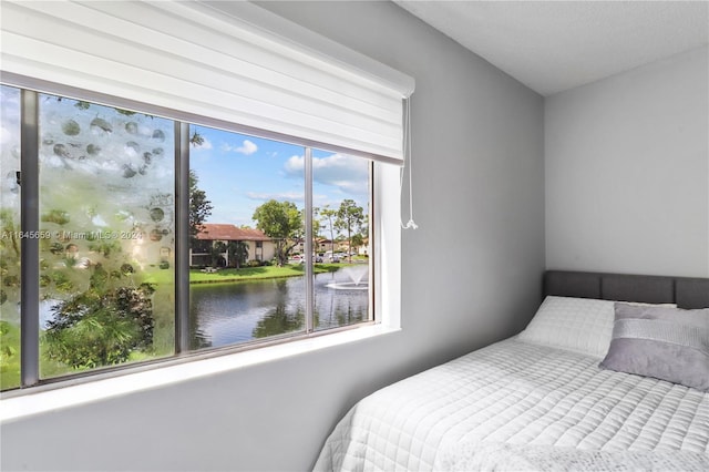 bedroom featuring a water view