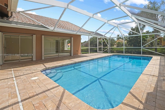 view of swimming pool with a lanai and a patio area