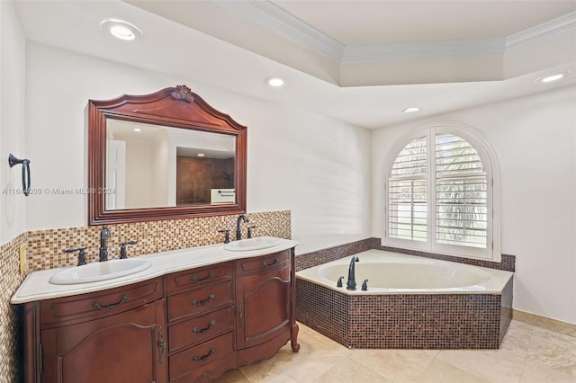 bathroom featuring backsplash, tiled tub, ornamental molding, and vanity