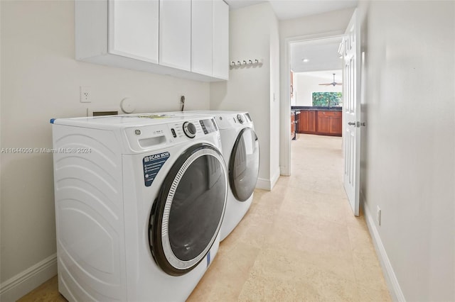 laundry area featuring washing machine and dryer, ceiling fan, and cabinets