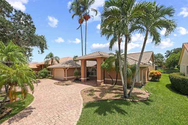 view of front of house featuring a garage and a front yard