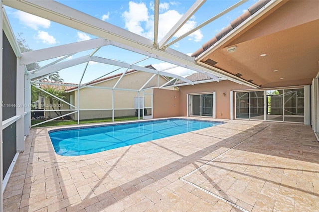 view of swimming pool with a patio and glass enclosure