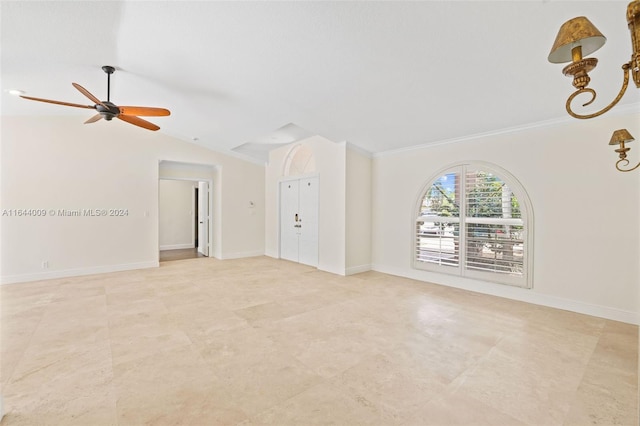 spare room featuring ornamental molding, vaulted ceiling, and ceiling fan