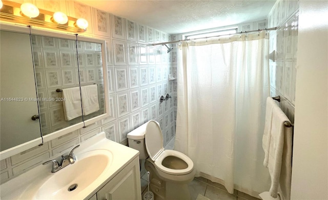 bathroom featuring toilet, tile patterned floors, vanity, a textured ceiling, and a shower with curtain