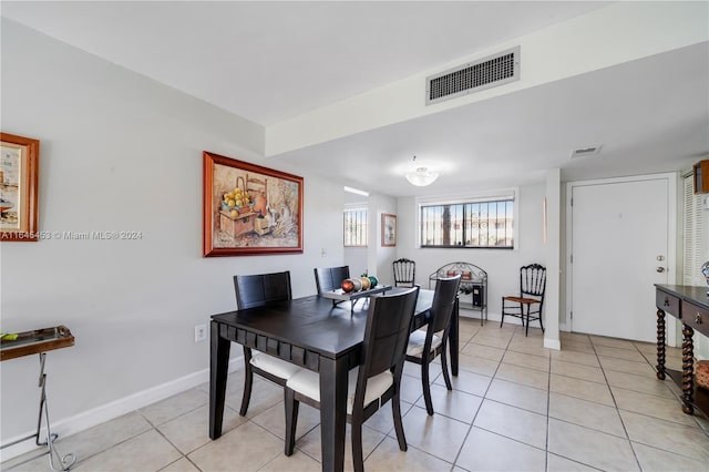 dining space featuring light tile patterned floors