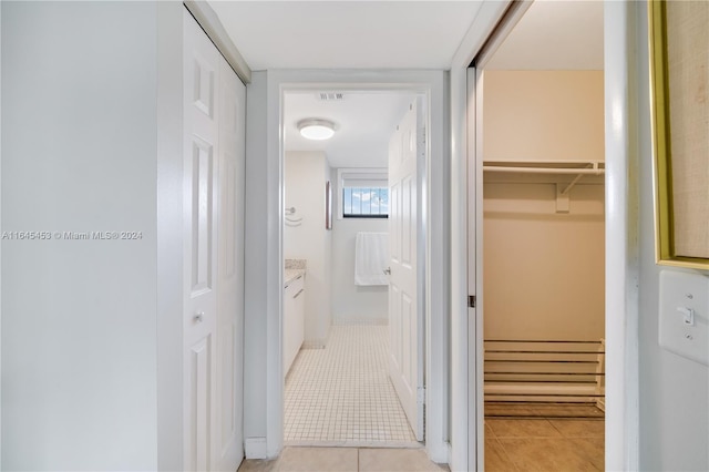 corridor featuring light tile patterned flooring