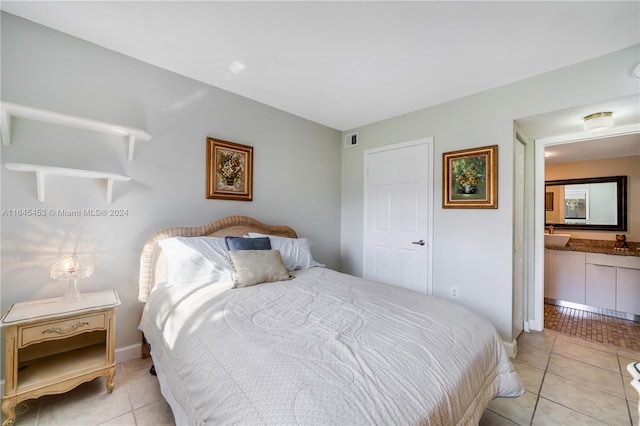 tiled bedroom featuring connected bathroom