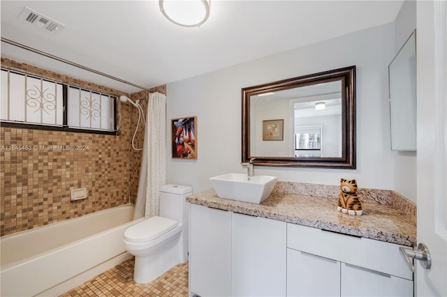 full bathroom with toilet, shower / bath combo, vanity, and tile patterned flooring