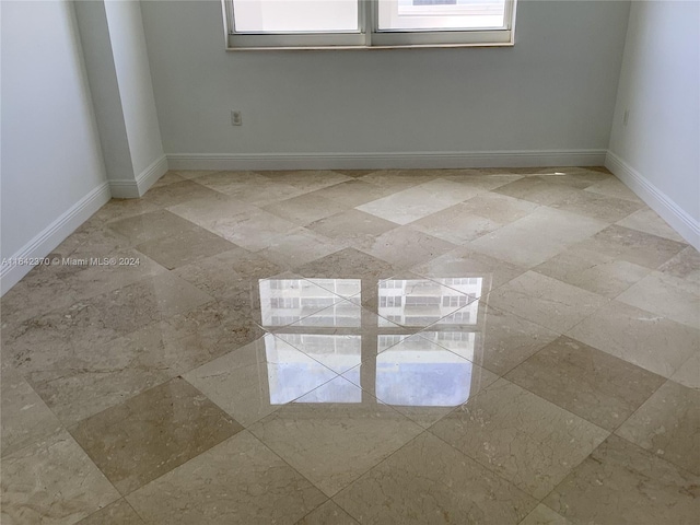 spare room featuring light tile patterned floors