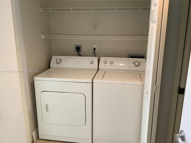 washroom featuring washer and clothes dryer