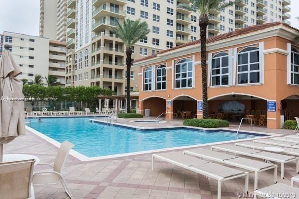 view of swimming pool featuring a patio area