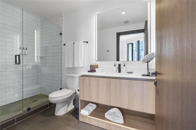 bathroom featuring an enclosed shower, tile patterned floors, toilet, and vanity