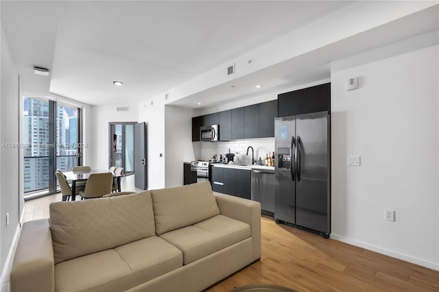 living room featuring light hardwood / wood-style flooring and sink