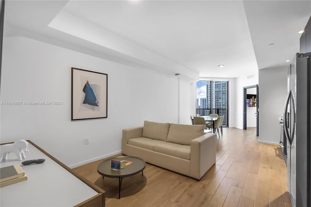 living room featuring expansive windows and light wood-type flooring