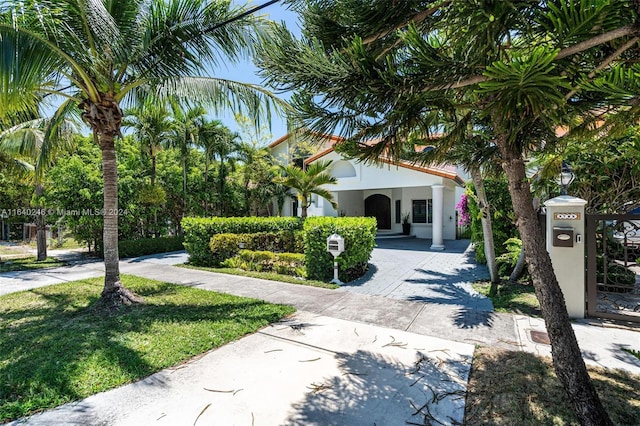 mediterranean / spanish house with a front yard