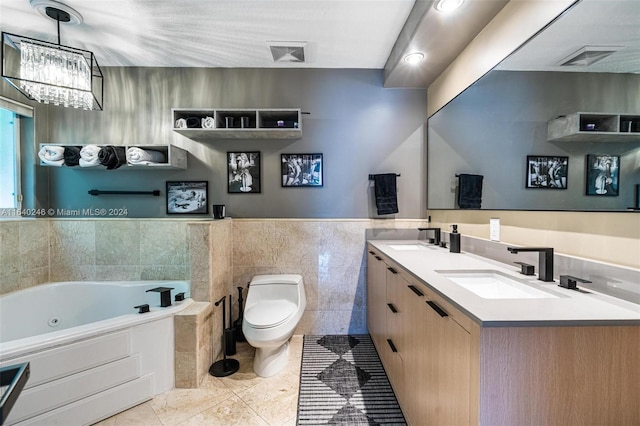 bathroom featuring a chandelier, toilet, tile patterned flooring, double vanity, and tile walls