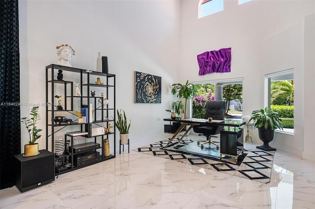 tiled home office with a towering ceiling