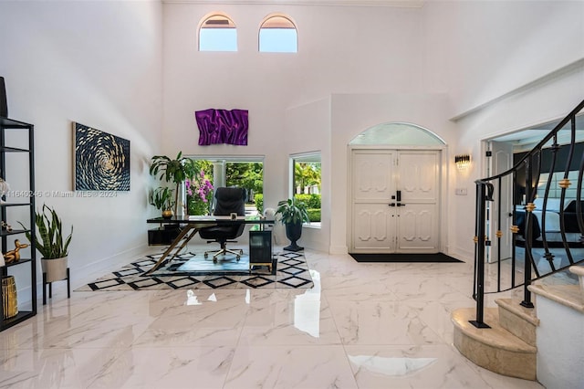 foyer with a high ceiling and light tile patterned floors