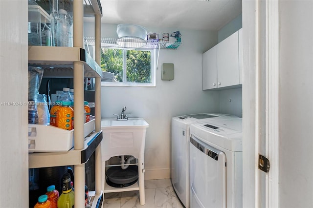 clothes washing area featuring light tile patterned flooring, independent washer and dryer, and cabinets