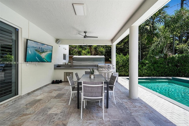 view of patio featuring ceiling fan and an outdoor kitchen