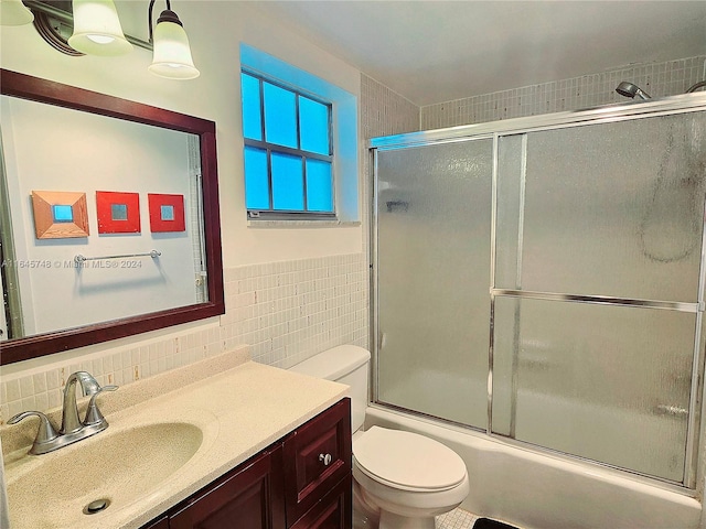 full bathroom with toilet, decorative backsplash, vanity, and tile walls