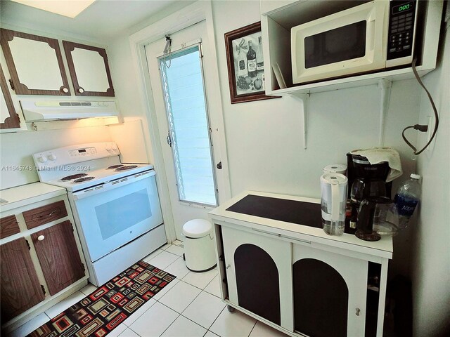 kitchen with white appliances and light tile patterned floors