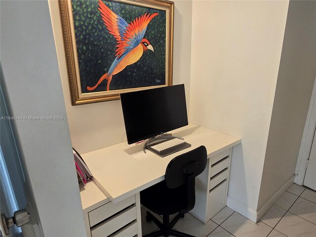 office featuring built in desk and light tile patterned flooring