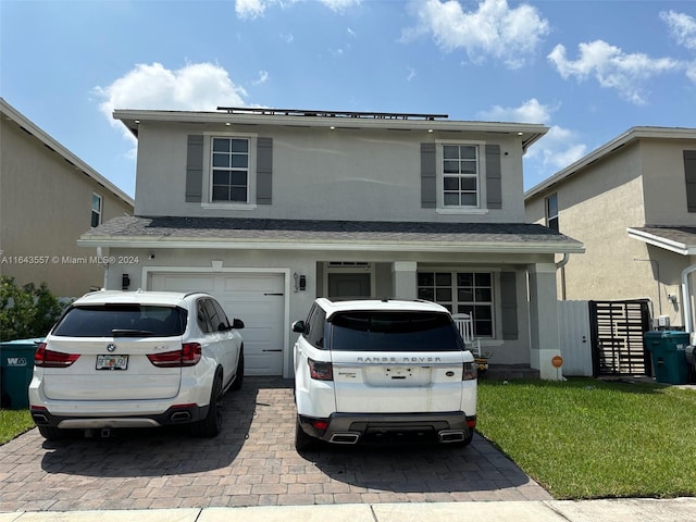 front of property featuring a garage and a front lawn