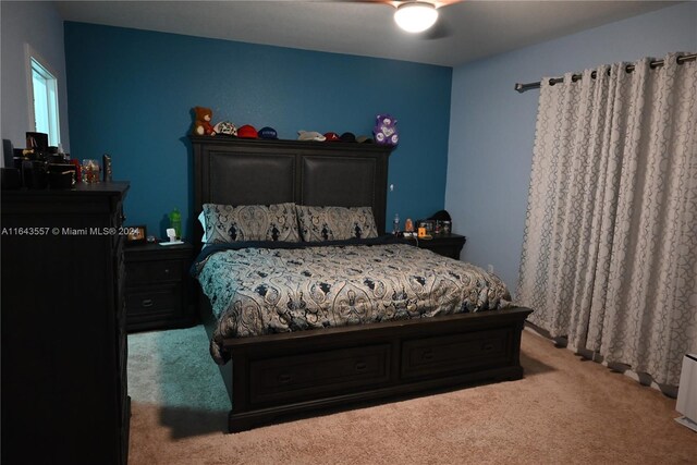 bedroom with ceiling fan and carpet