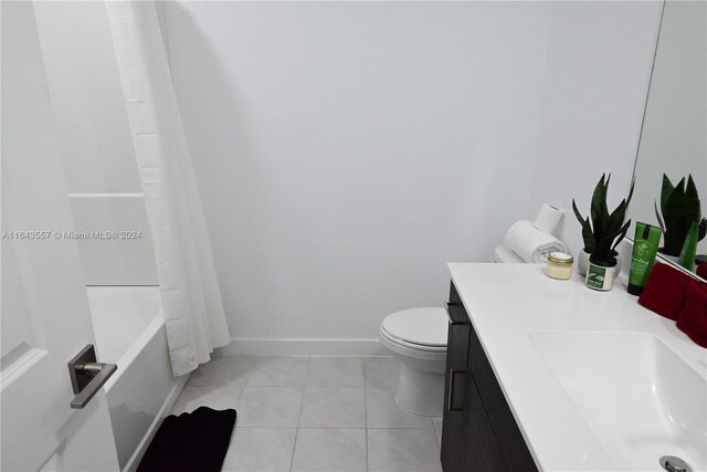 full bathroom with vanity, toilet, tile patterned floors, and shower / bath combo with shower curtain