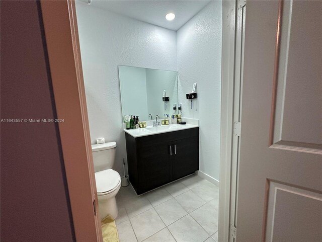 bathroom featuring vanity, toilet, and tile patterned floors